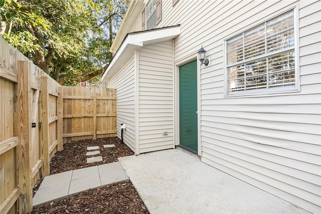 view of exterior entry with a patio