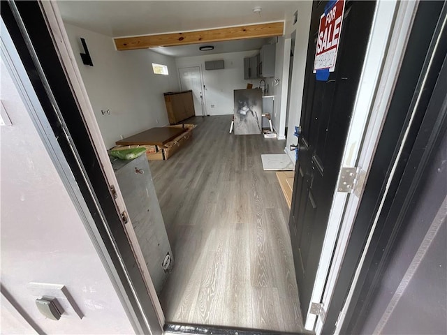 hallway featuring sink and light hardwood / wood-style flooring