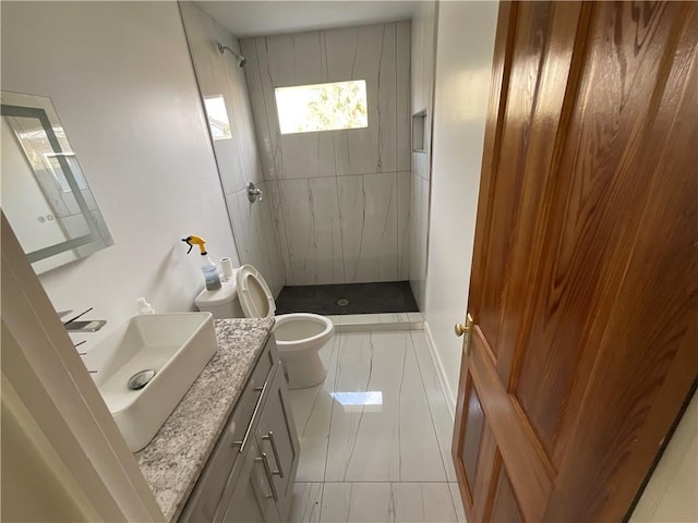 bathroom featuring tiled shower, vanity, toilet, and tile patterned floors