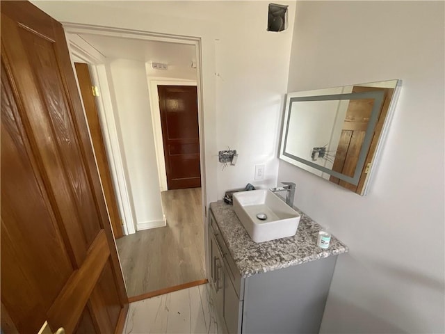 bathroom with vanity and hardwood / wood-style floors