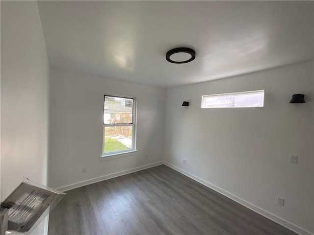 unfurnished room featuring dark wood-type flooring