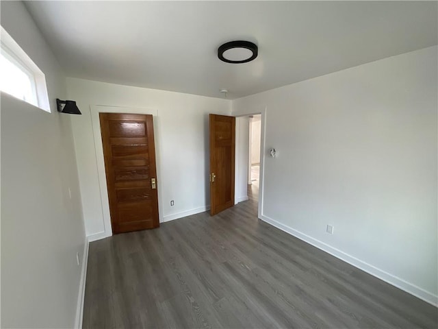 unfurnished bedroom featuring dark hardwood / wood-style flooring