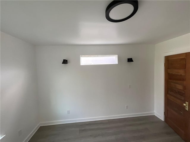 unfurnished room featuring dark hardwood / wood-style flooring