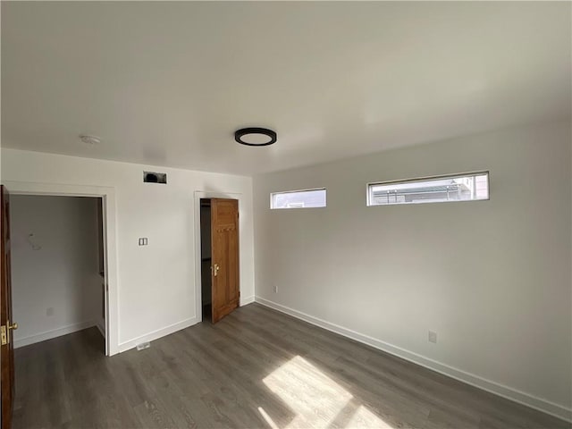 unfurnished room with dark hardwood / wood-style floors