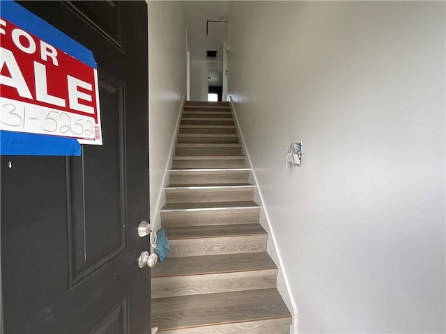 stairs with hardwood / wood-style floors