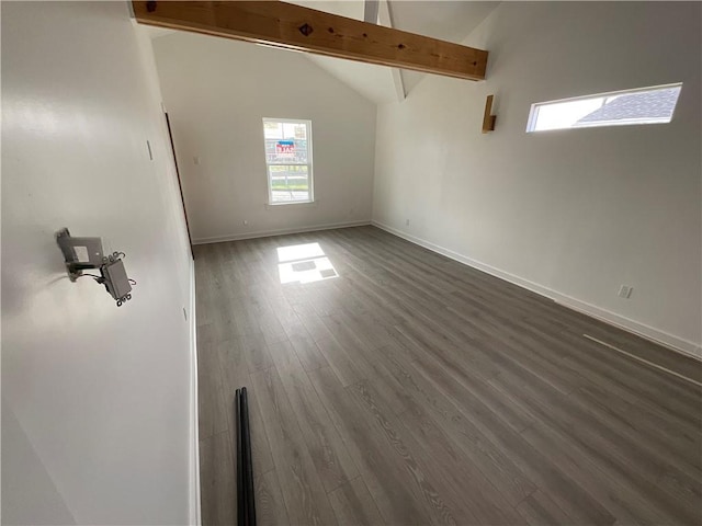 empty room with dark hardwood / wood-style flooring, beam ceiling, and high vaulted ceiling