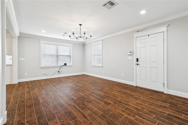 unfurnished living room with crown molding, dark hardwood / wood-style floors, and a notable chandelier