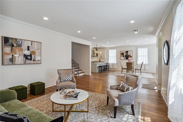 living room with hardwood / wood-style flooring and crown molding