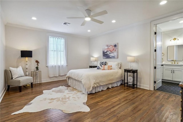 bedroom with ornamental molding, dark hardwood / wood-style floors, and ensuite bathroom