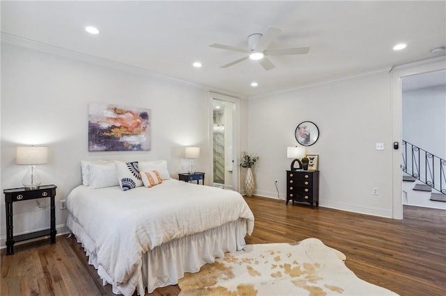 bedroom featuring crown molding, ceiling fan, and dark wood-type flooring