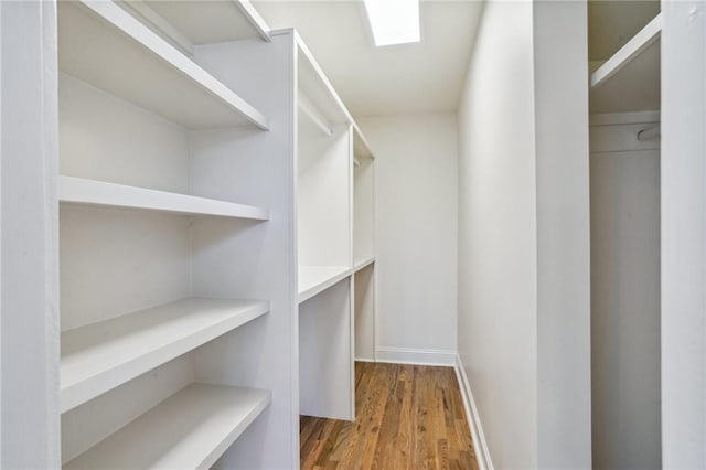 walk in closet with hardwood / wood-style floors