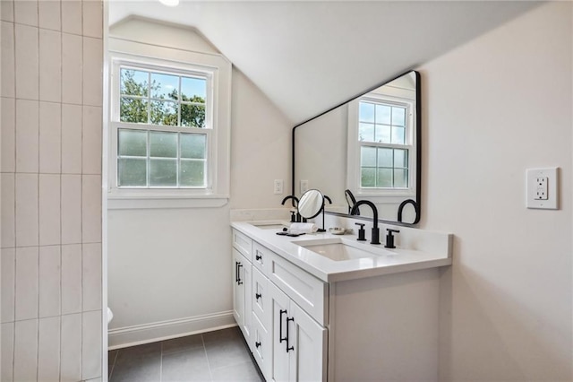 bathroom featuring vanity, tile patterned floors, and lofted ceiling