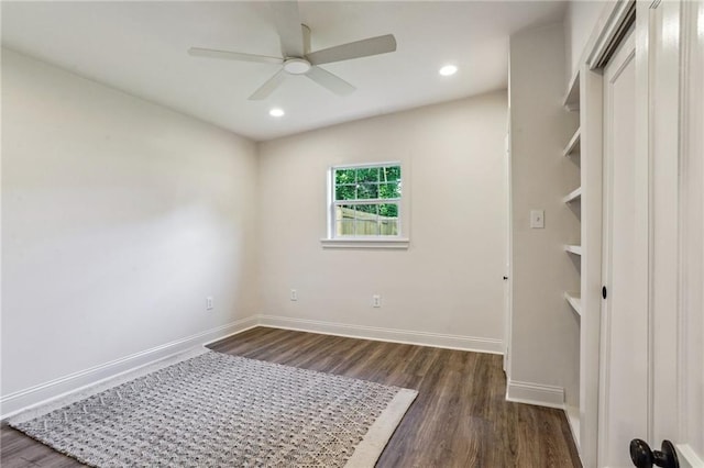 unfurnished bedroom with ceiling fan and dark hardwood / wood-style floors