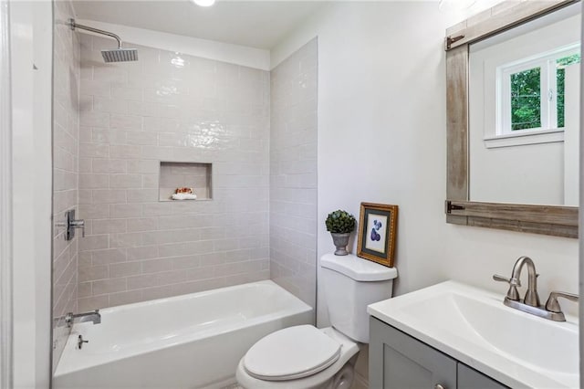 full bathroom featuring vanity, toilet, and tiled shower / bath