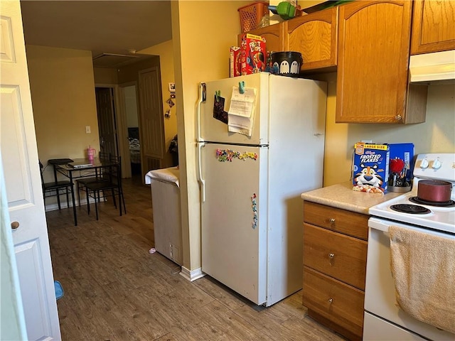 kitchen featuring hardwood / wood-style flooring and white appliances