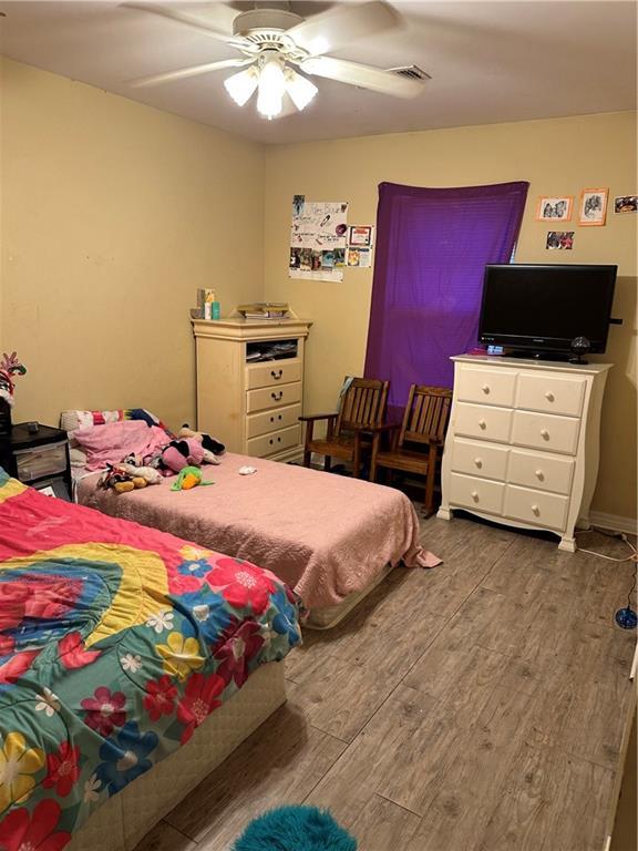 bedroom featuring hardwood / wood-style floors and ceiling fan