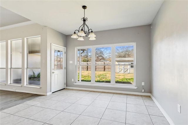 unfurnished dining area featuring a notable chandelier and light tile patterned flooring