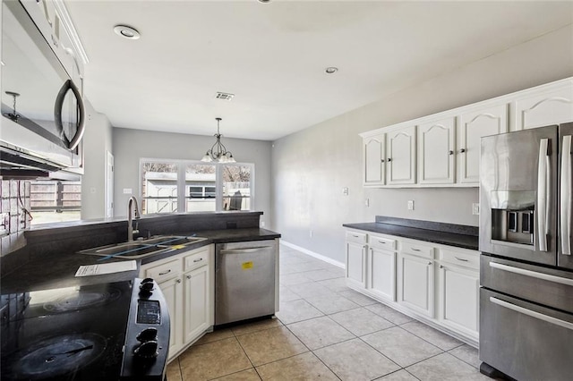 kitchen featuring stainless steel appliances, sink, hanging light fixtures, and white cabinets