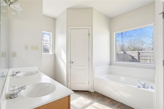 bathroom featuring vanity and a bath