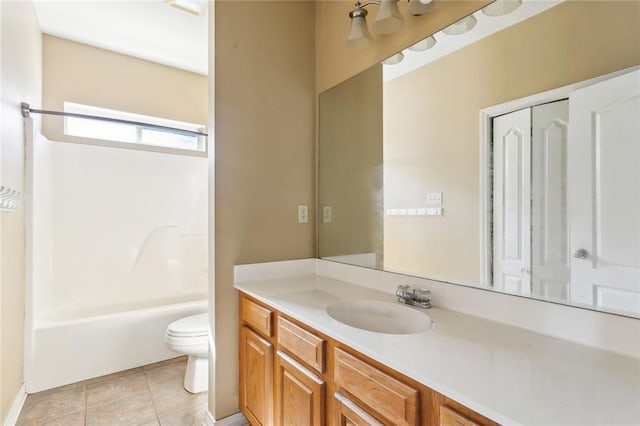 full bathroom featuring tile patterned floors, vanity, toilet, and washtub / shower combination