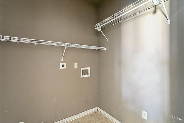 clothes washing area featuring light tile patterned flooring, hookup for an electric dryer, and hookup for a washing machine