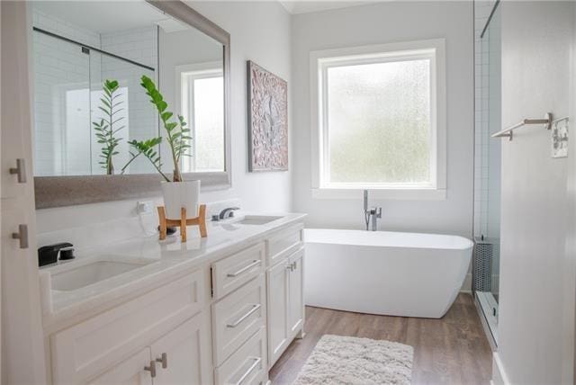 bathroom with vanity, hardwood / wood-style floors, and separate shower and tub