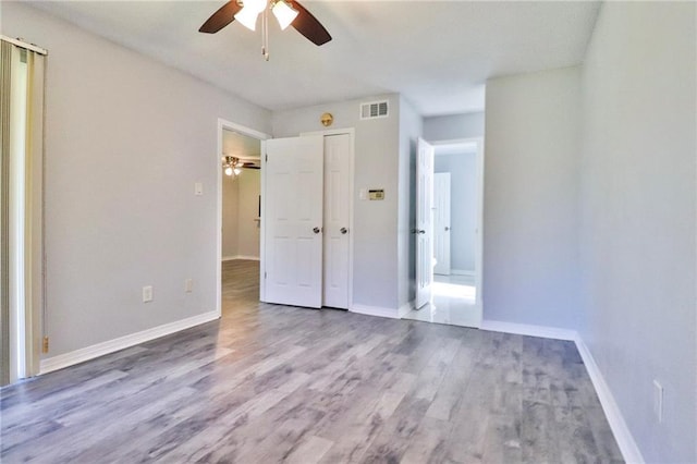 unfurnished bedroom featuring wood-type flooring and ceiling fan