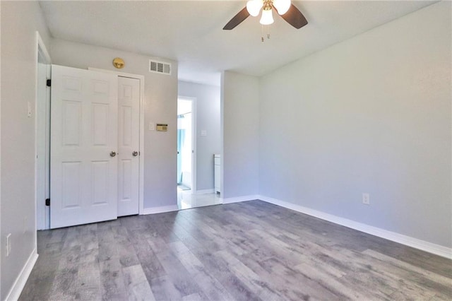 spare room with hardwood / wood-style flooring and ceiling fan