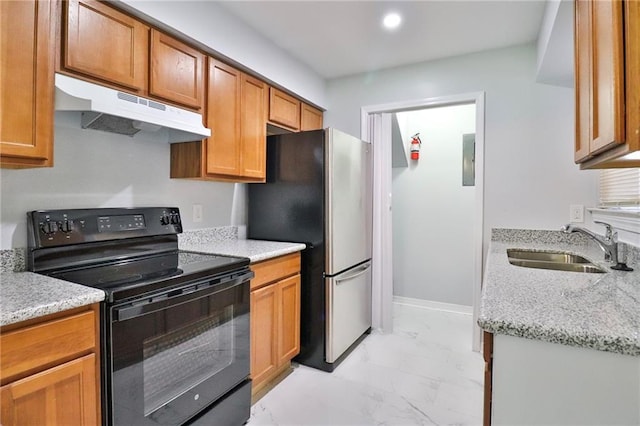 kitchen with stainless steel refrigerator, black range with electric stovetop, sink, and light stone counters