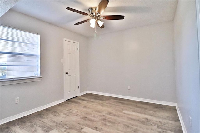 empty room featuring hardwood / wood-style flooring and ceiling fan