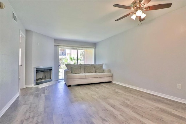 unfurnished living room featuring light hardwood / wood-style flooring and ceiling fan