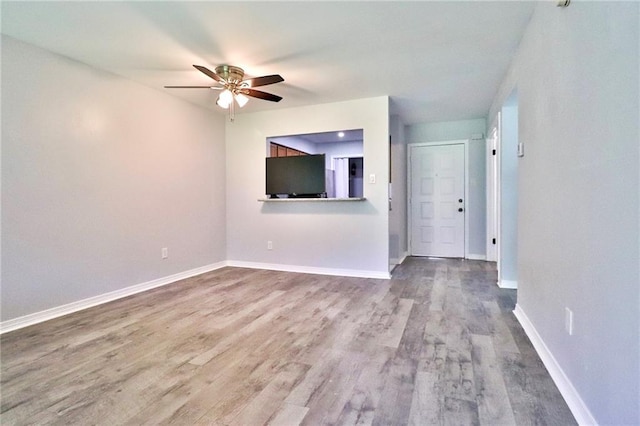 unfurnished living room featuring hardwood / wood-style floors and ceiling fan