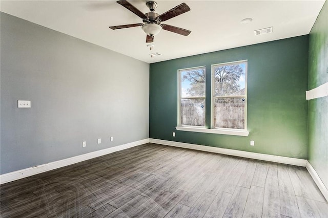 empty room with hardwood / wood-style flooring and ceiling fan