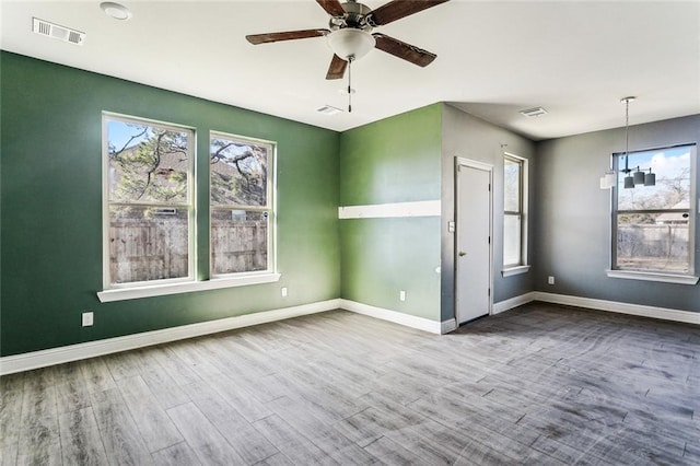 spare room with hardwood / wood-style flooring and ceiling fan