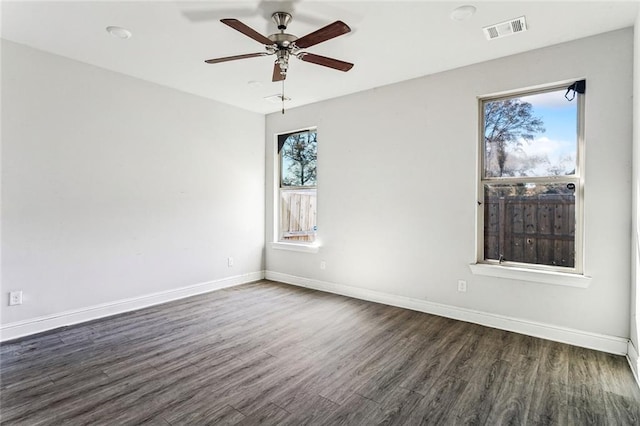 empty room with dark hardwood / wood-style flooring and ceiling fan