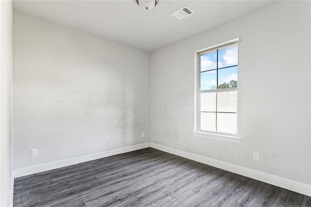 empty room with dark wood-type flooring