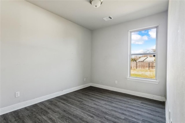 empty room with dark hardwood / wood-style flooring