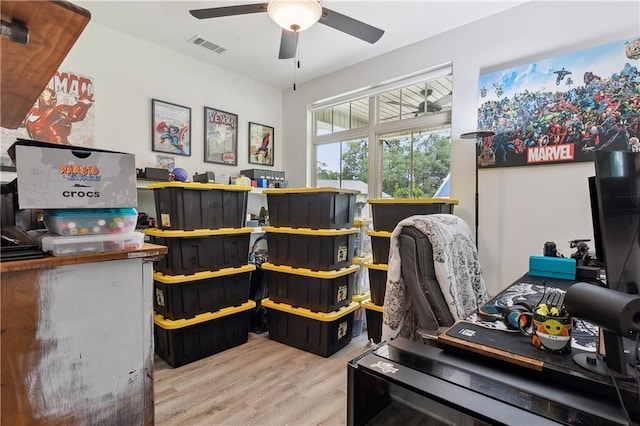 office area with light hardwood / wood-style flooring and ceiling fan