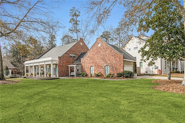 view of front of home featuring concrete driveway, brick siding, an attached garage, and a front lawn