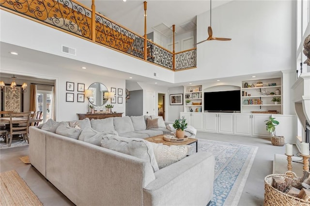 living area with recessed lighting, a ceiling fan, visible vents, finished concrete flooring, and built in features