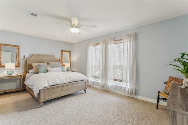 bedroom with baseboards, a ceiling fan, visible vents, and light colored carpet