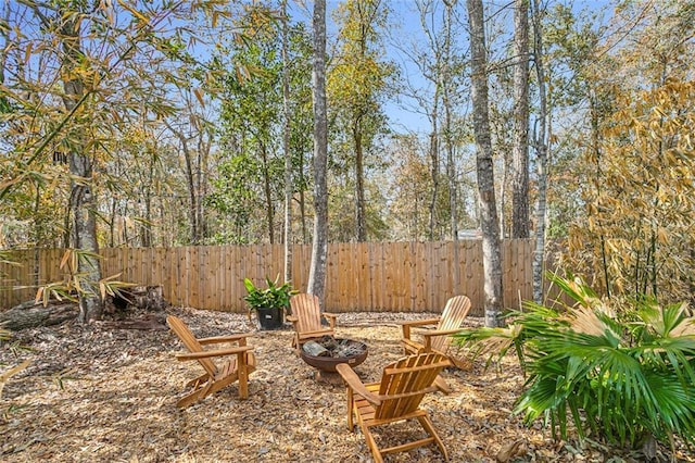 view of yard featuring a fire pit and fence