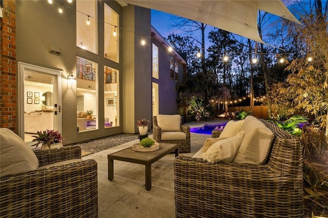 view of patio featuring an outdoor hangout area, fence, and a fenced in pool