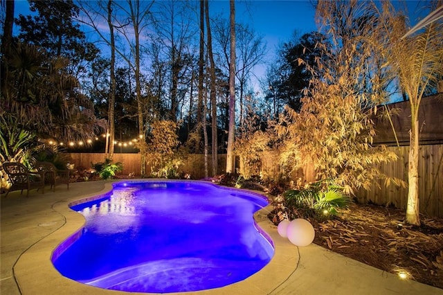 view of swimming pool with a fenced in pool, a fenced backyard, and a patio