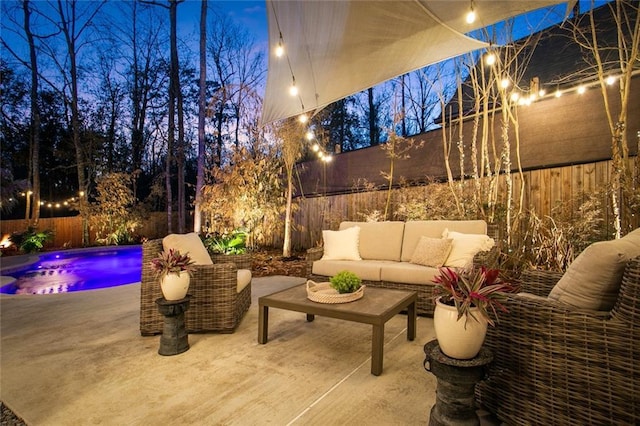 view of patio with outdoor lounge area, a fenced backyard, and a fenced in pool