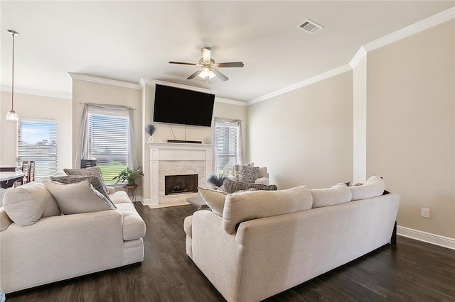 living room with dark hardwood / wood-style flooring, ceiling fan, and a healthy amount of sunlight