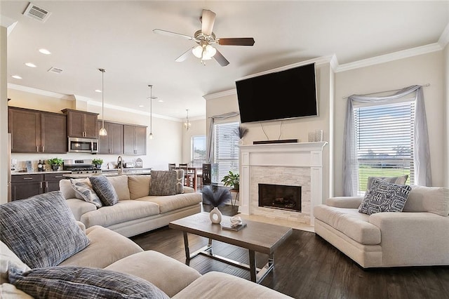 living room featuring ornamental molding, plenty of natural light, and dark hardwood / wood-style floors