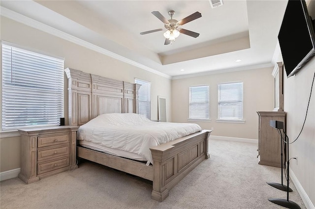 carpeted bedroom featuring crown molding, ceiling fan, and a tray ceiling