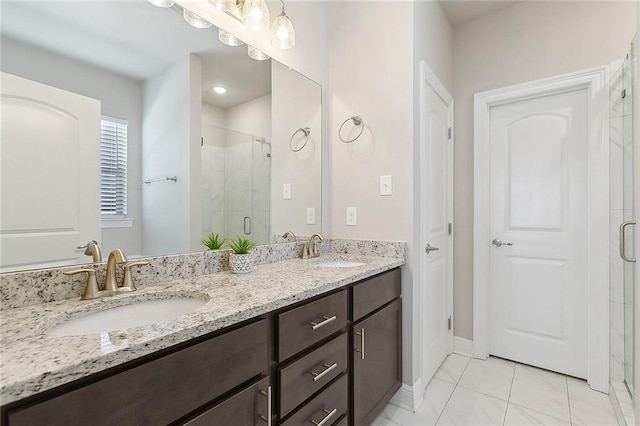 bathroom featuring vanity, a shower with shower door, and tile patterned floors