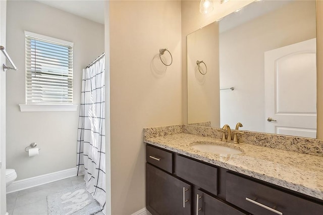 bathroom featuring vanity, tile patterned floors, and toilet